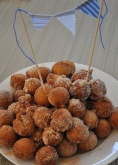 a white plate topped with sugar covered donuts