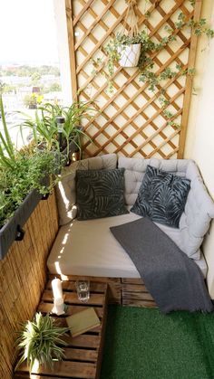 a couch made out of wooden pallets on top of a grass covered roof terrace