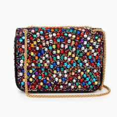 Adorned with rhinestones in stunning half-circular patterns, this clutch is available in both peach and a vibrant colorful variant, ensuring a perfect match for every style. Its sleek and compact shape ensures easy carrying, while the radiant rhinestones add a touch of glamour that is simply irresistible. This bag also features a chain strap that caters to your comfort. The Amari Gems Clutch Bag is more than just a bag; it's a statement piece. Elegant Multicolor Clutch With Rhinestones, Trendy Multicolor Clutch Evening Bag, Multicolor Evening Bag For Events, Glamorous Multicolor Bags For Events, Glamorous Multicolor Event Bags, Multicolor Rhinestone Evening Bag For Events, Chic Multicolor Clutch Evening Bag, Glamorous Embellished Multicolor Bags, Glamorous Multicolor Embellished Bags