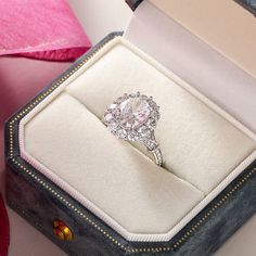 an engagement ring sits in a velvet box