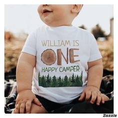 a baby wearing a white shirt with the words william is one happy camper on it