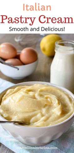 a bowl filled with cream next to some eggs