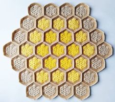 a crocheted doily with yellow and white hexagons on it