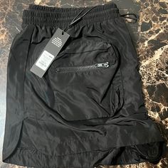 Fashion Nova - Nylon Sporty Shorts W/ Zipper Pockets - Black - Size Xl - Brand New Nylon Drawstring Shorts For Streetwear, Streetwear Nylon Drawstring Shorts, Black Nylon Short Bottoms, Stretch Nylon Shorts For Streetwear, Black Nylon Athletic Shorts With Elastic Waistband, Black Nylon Bottoms With Side Pockets, Black Nylon Bottoms With Drawstring, Black Nylon Drawstring Bottoms, Spring Streetwear Nylon Shorts