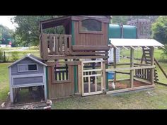 there is a chicken house with a wooden roof and ladders on the top floor