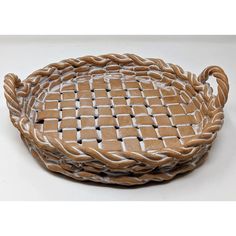 a brown and white basket sitting on top of a table