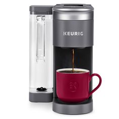 keurig single serve coffee maker with red cup and black handle, on white background