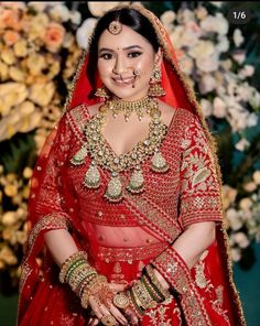 a woman wearing a red bridal outfit