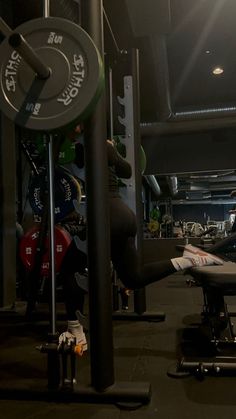 an empty gym room with weight machines and other equipment