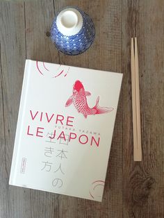 a book and chopsticks on a wooden table