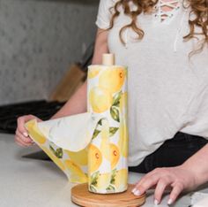 a woman sitting at a table with a yellow umbrella and some napkins on it