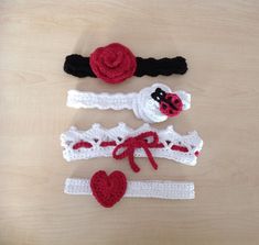 three crocheted headbands with ladybug and heart