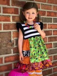 "Our Halloween Platinum Party style dress is fashioned in our signature knit flutter style bodice & a cotton full ruffle skirting, perfect for wowing the crowd! Custom designed from a delightful mix of prints that please & colors that pop. Great for October outings, Halloween birthday parties, Fall festivals, Fall portraits, Halloween parties, & everyday wear! All designs are tagged in the even size. Size LENGTH: 12mo/18mo: 17\" 2/3: 21\" 4/5: 24\" 6/7: 26\" 8: 28\" 8/10: 31\" 12: 33 Cute Halloween Ruffle Dresses, Playful Black Dress For Costume Party, Cute Ruffled Halloween Dresses, Frozen Birthday Dress, Spider Dress, Halloween Boutique, Girls Halloween Dress, Circus Outfits, Halloween Toddler