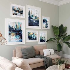 a living room filled with furniture and pictures on the wall above it's couch