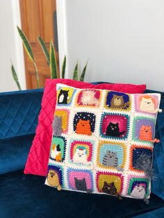 a crocheted pillow sitting on top of a blue couch