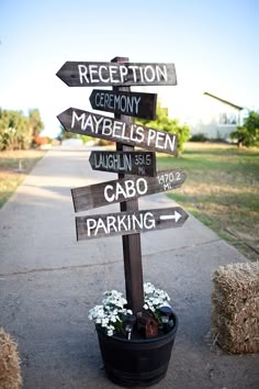 a wooden pole with many signs on it