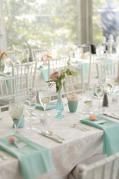 the tables are set with white and blue linens