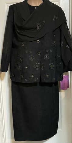 Absolutely beautiful NWT New SOGIC Suits of God in Church Black Ultrasuede Floral 2pc Skirt Suit Set. Does come with an attached sheet Shaw, can be attached to the other shoulder or hang. Ultra suede material feels like real suede, gold accents and stitching! Jacket Approx. Measurements: •Underarm seam to underarm seam 27” •Underarm seam to shortest part of bottom hem 20” Skirt from waist to hem 35” We have many new and gently used designer/name brand clothing from sizes 0-6X, including Chico’s, Black Evening Sets For Spring, Black Skirt Suit For Fall Party, Black Skirt Suit For Party In Fall, Fitted Black Skirt Suit For Night Out, Black Fitted Skirt Suit For Night Out, Skirt Suit Set, Designer Name, Brand Clothing, Suede Material