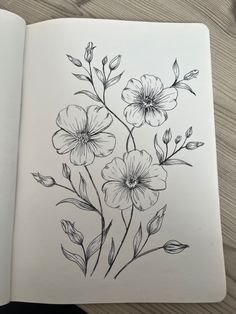 an open book with flowers drawn on it