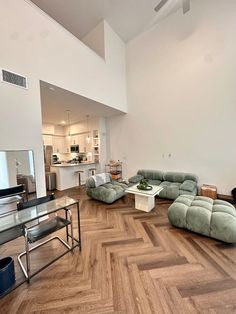 a living room filled with furniture and a flat screen tv on top of a hard wood floor