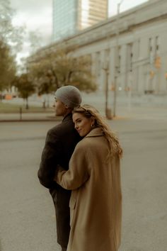 a man and woman walking down the street