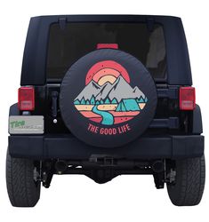 a tire cover that says the good life with mountains and clouds in the background on a black jeep