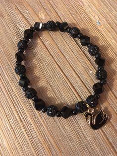 "Inspired by the song Black Swan. This bracelet is made from black glass beads and a black swan charm.  Bracelet measure approx. 7.5\" and is on elastic cording.  Surprise BTS photocard included.  Always supervise your child while wearing this bracelet as the small parts may pose a choking hazard" Black Charm Bracelet, Kpop Bracelet, Bts Black Swan, Bts Bracelet, Bts Photocard, Bts Black, Bracelet Ideas, Black Swan, The Song