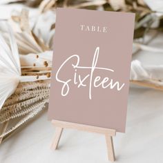 a table sign sitting on top of a wooden easel