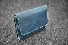 Wallet // Hand-stitched unisex wallet made of a quality vegetable tanned cow leather. _ _ _ _ _ _ _ _ _ _ _ _ _ _ _ _ _ _ _ _ _ _ _ _ _ _ _ _ _ _ _ _ _ _ _ _ _ _ _ _ _ _ _ _  MAKER'S NOTES Elegant, simple wallet with three pockets for coins and other stuff, one additional pocket in the flap for credit cards and bills. Dense short stitches in natural white color (standard), or in any custom color. Ages very nicely. Edges of leather are hand dyes and waxed. _ _ _ _ _ _ _ _ _ _ _ _ _ _ _ _ _ _ _ _ Handmade Blue Wallet For Everyday Use, Blue Handmade Wallet, Handmade Blue Leather Wallet, Blue Leather Trifold Wallet For Everyday Use, Simple Wallet, Leather Portfolio, Leather Books, Money Clip Wallet, Stitching Leather