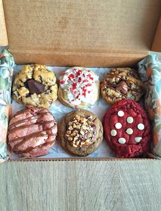 a box filled with assorted cookies and pastries