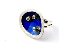 Handmade Modern Statement Ring.  Sterling silver, 18k gold,  Kiln-fired enamel contemporary design in  blue enamel with 3 matching zircons. Solid ring with unique design inspired by my vision of modern Japanese esthetics. Fun and quirky. You'll love the look and feel of this ring and it brightens up whatever you are wearing! Weighs 15g, is 3 cm wide and 3.4 cm high. Japan CollectionCustomized to your ring size.  Ready to ship. NOW ON SPECIAL OFFER. Was $195, NOW $175.Please feel free to browse i Modern White Gold Rings With Enamel, Modern Enamel Ring For Gift, Blue Enamel Polished Round Ring, Blue Polished Enamel Ring, Modern White Gold Enamel Ring For Anniversary, Blue Enamel Ring With Polished Finish, Blue Enamel Ring With Polished Finish As Gift, Blue Enamel Ring With Polished Finish For Gift, Modern Enamel Ring With Polished Finish For Gift