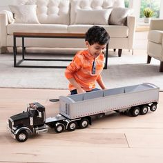 a young boy playing with a toy truck