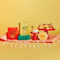 a table topped with lots of food and confection on top of a cloth