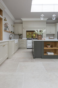 Chastleton Ivory porcelain tiles in a cream and green kitchen.