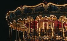 a merry go round is lit up at night