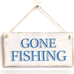 a sign that says gone fishing hanging on a wall