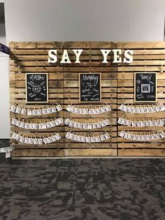 there is a sign that says say yes in front of some pictures on the wall