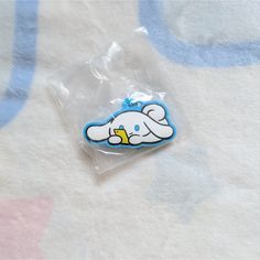 a blue and white sticker sitting on top of a bed