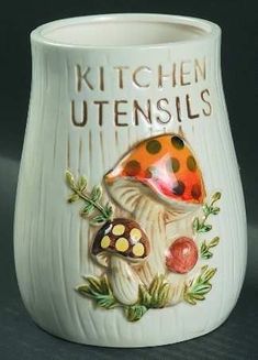 a ceramic cup with a ladybug on it and the words kitchen utensils