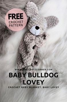 a crocheted teddy bear laying on top of a white fur covered floor with the text free crochet pattern for baby bulldog lovey