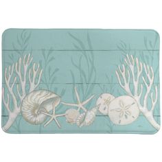 a bath mat with shells and corals on it