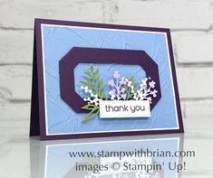 a close up of a card with flowers and a thank you sign in the middle