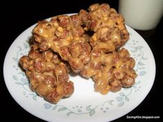 some kind of food on a plate next to a glass of milk