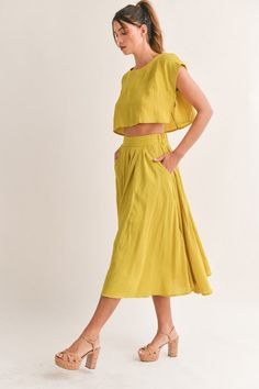 The Savannah Skirt Set is your perfect go-to for the summer. Crafted from a lightweight linen-like fabric, the midi-flare skirt comes with a side pocket for convenience, while the crop top offers an effortless fit. Keep cool and stylish in this comfortable and timeless set. This item runs true to size. Skirt has elastic in the waist. The top is a wide cut with no stretch. Lining. Self: 95% Rayon 5% Spandex Linning: 100% Cotton Skirt And Top Coord Set, Summer Coord Set, Wrap Skirt Outfit, Pink And Red Dress, Short Sleeve Floral Dress, Black And Blue Dress, Mustard Yellow Color, Crop Top Skirt Set, Coord Set