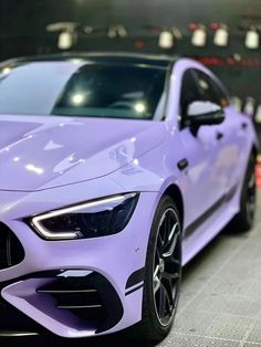 a purple sports car parked in a garage