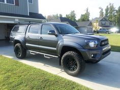 a gray truck parked in front of a house