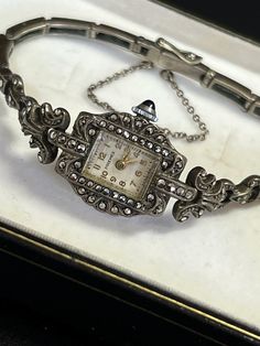 Rare Art Deco ladies' mechanical watch with hand-made marcasite by Premex, circa 1940s. The watch is used, in excellent condition, it runs. The inside diameter of the watch when fastened is 16 cm and therefore fits a wrist with a circumference of up to 15.5 cm. The watch has a good clasp with additional security in the form of a small clasp on the side of the bracelet and a protective chain. This watch is suitable for both everyday use and for complementing collections. The watch is sold without Luxury Art Deco Watch With Manual Winding, Art Deco Lady, Women Wrist Watch, Mechanical Watch, Wrist Watches, Jewellery And Watches, Womens Watches, Wrist Watch, Ukraine