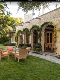 an outdoor patio with chairs and tables in the grass