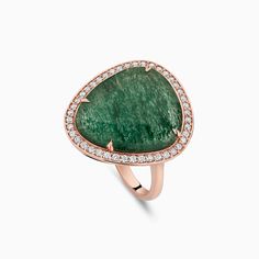 a green stone and diamond ring on a white background