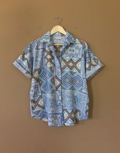 "Authentic vintage short sleeve button down shirt with 90's abstract design and oversized fit. Dates from early to late 90's. This shirt is in great clean condition with little signs of previous wear. Full button down front. Soft 100% cotton. Still has many years of wear left. Measurements (taken zipped/buttoned up and laid comfortably flat) x2 for circumference No Tag Size (Fits like Oversized Large) Shoulders 46\"/48\" Chest 44\" Bottom hem circumference 44\" Sleeve 6\" Top arm circumference 1 Bohemian Short Sleeve Shirt, Retro Button-up Summer Shirt, Retro Button-up Shirt For Summer, Vintage Button-up Hawaiian Shirt For Summer, Casual Camp Shirt With Vintage Print And Relaxed Fit, Casual Camp Shirt With Vintage Print In Relaxed Fit, Casual Retro Print Button-up Shirt, Casual Camp Shirt With Retro Print For Spring, Retro Relaxed Fit Button-up Shirt